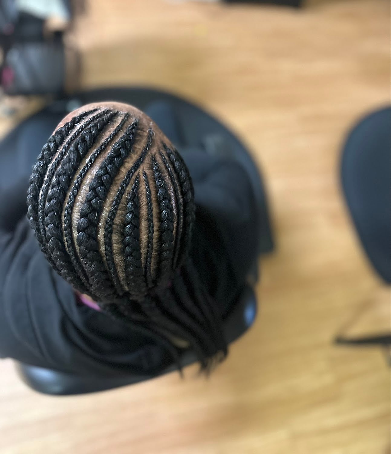 Cornrows gathered into a braided ponytail